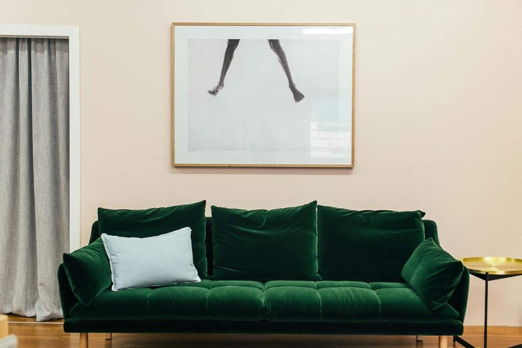 Elegant living room with a green velvet sofa and contemporary decor.